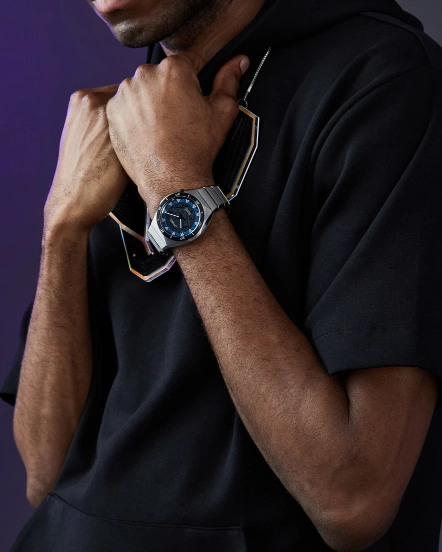 Citizen Black Panther AW1668-50W worn with a black hoodie and Marvel collector’s card, highlighting the Black Panther-inspired dial and silver-tone bracelet.