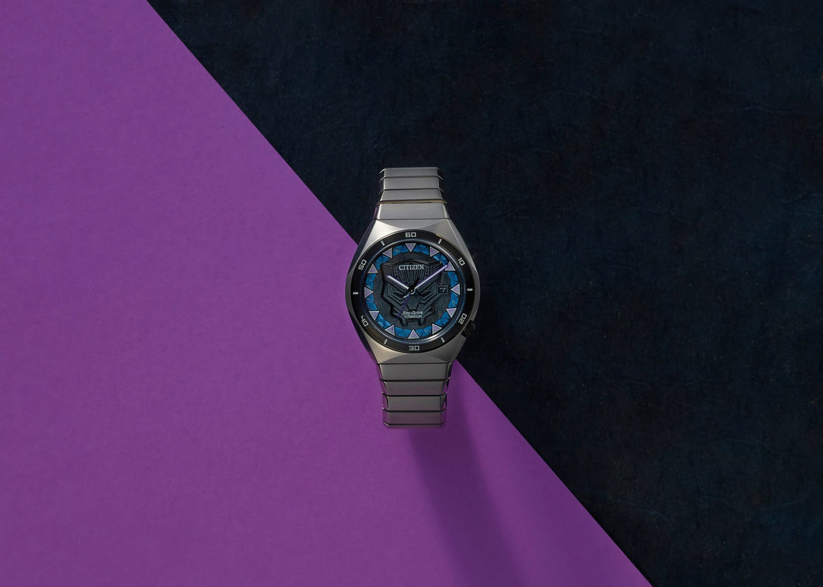 Citizen Black Panther AW1668-50W displayed on a purple and black background, featuring the patterned dial, gray bezel, and Super Titanium bracelet.