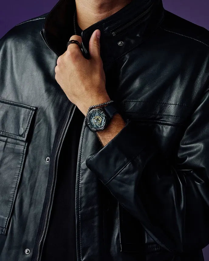 Citizen Black Panther 60th Anniversary AW1858-03W Eco-Drive watch with dimensional black dial, gold Black Panther mask logo, purple minute track, 42mm black IP stainless steel case, black silicone strap, sapphire crystal, and 100m water resistance.