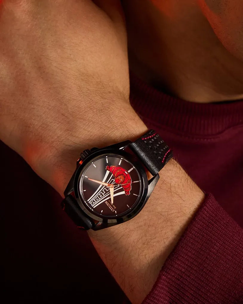 Citizen Marvel Stark AW2095-41W Eco-Drive watch worn on wrist with burgundy styling, featuring Tony Stark in flight dial artwork, black case, and red-stitched leather strap.
