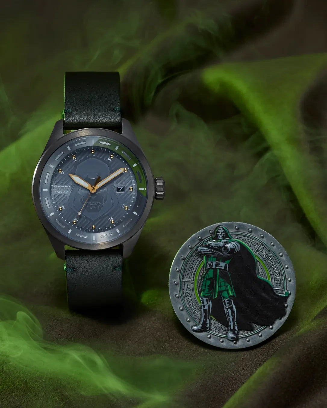 Citizen Avengers Dr. Doom AW5027-44W displayed with collectible Doctor Doom coin, featuring gray mask-inspired dial, gold-tone hands, and green leather strap.
