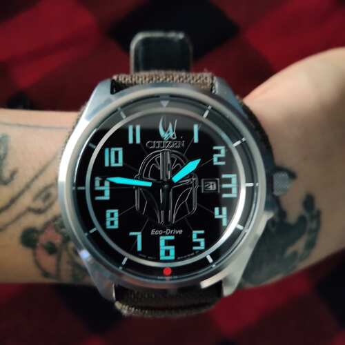 CITIZEN Star Wars Mandalorian AW1411-05W – silver-tone Eco-Drive watch with Mandalorian helmet dial, etched Grogu case back, rugged brown leather strap, and WR200 water resistance.