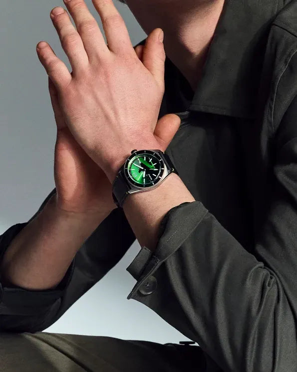 Lifestyle image of the Citizen Star Wars Luke Skywalker AW1910-48W on wrist, showing the green-accented Star Wars dial, silver-tone case, and black leather strap with green stitching.