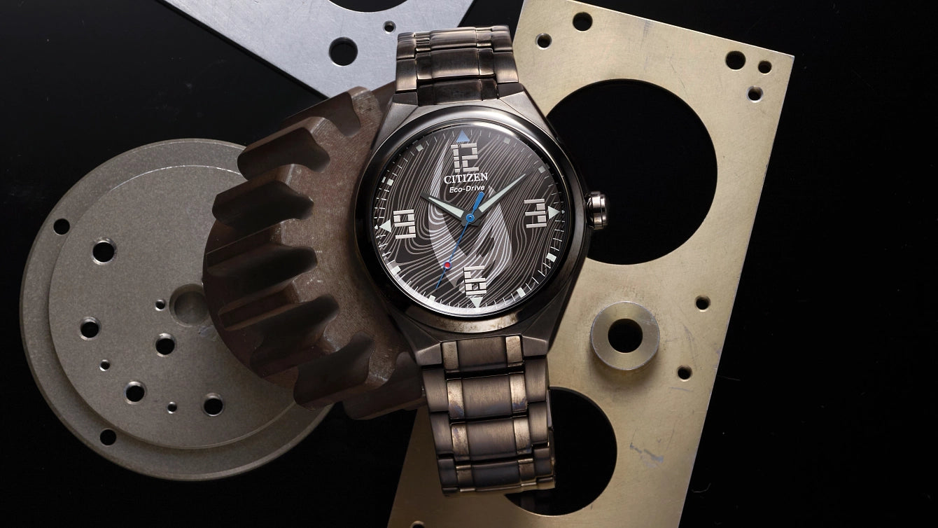 CITIZEN Star Wars Mandalorian AW2045-57W – matte black Eco-Drive watch with Mudhorn signet dial, etched helmet case back, Beskar-inspired bracelet, and WR100 water resistance.