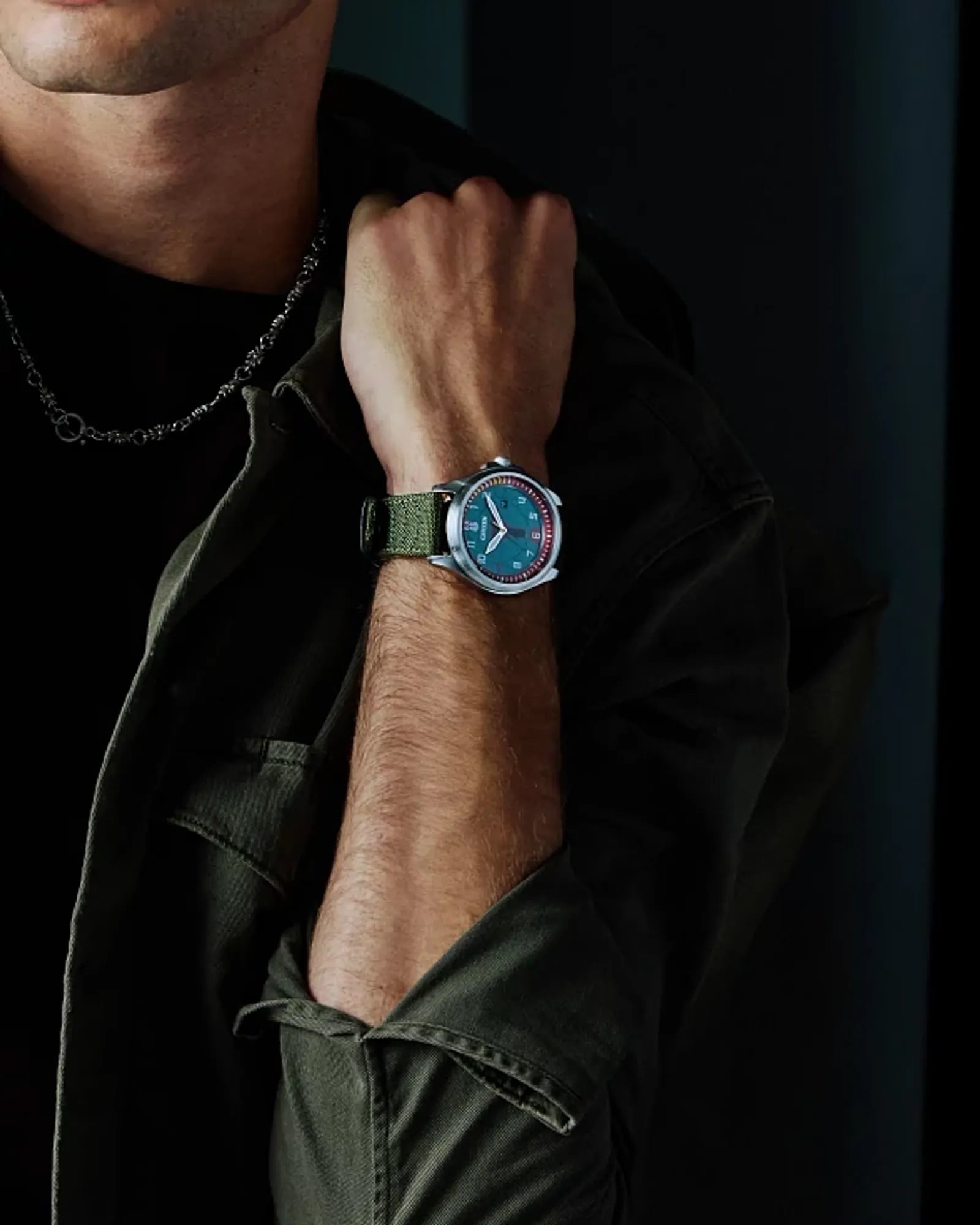 Person wearing a watch with a dark background