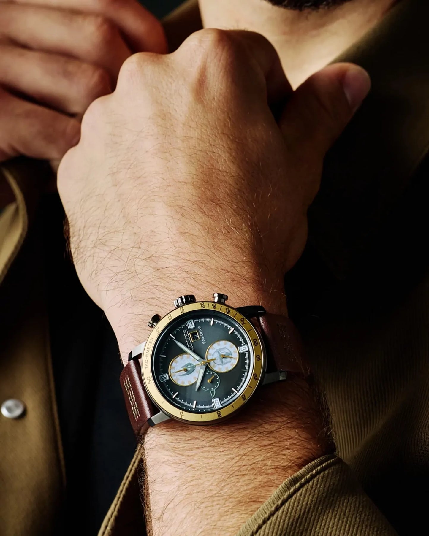 Close-up of a wrist wearing a detailed watch with a brown leather strap.