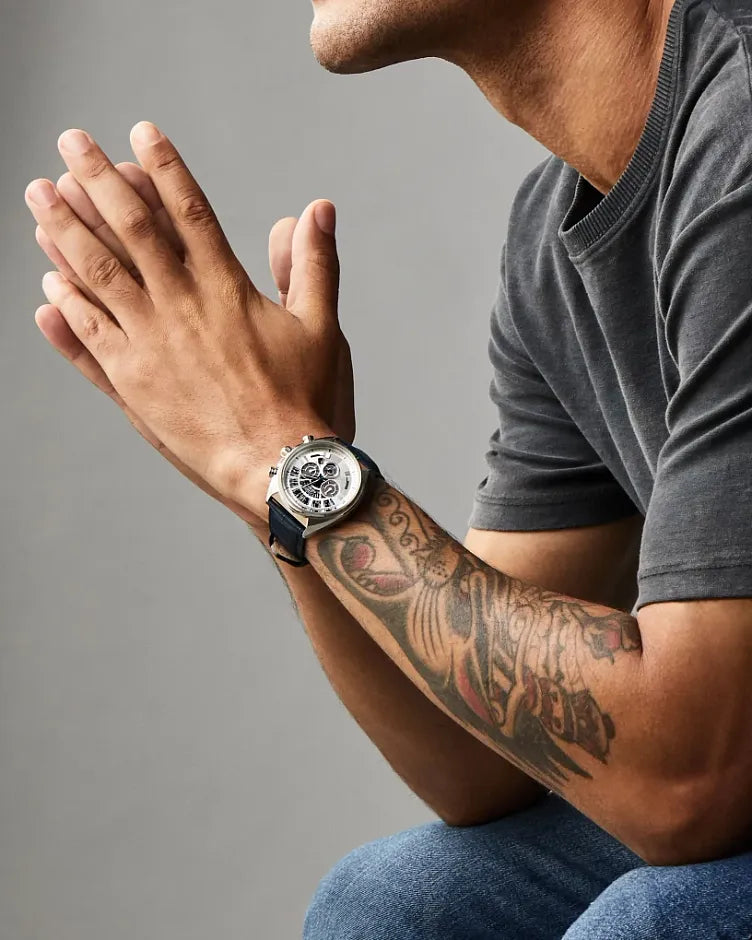 Person wearing a watch with a gray background