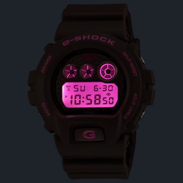 Black G-Shock digital watch with pink display on a dark background