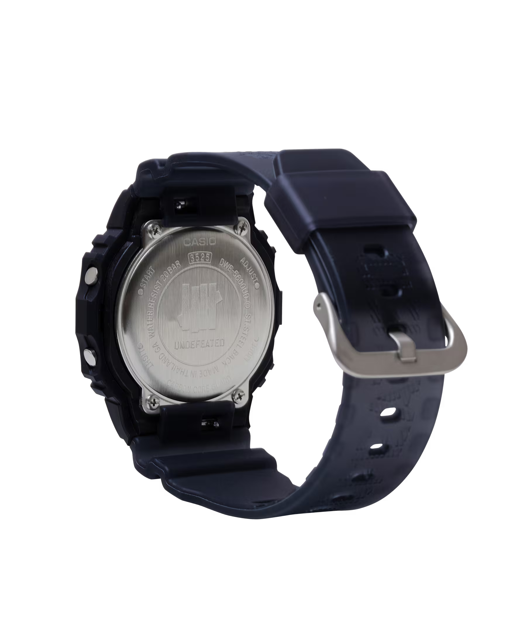 Casio G-SHOCK DWE5600UD-1 UNDEFEATED collaboration model with matte black Carbon Core Guard case, semi-translucent resin band featuring UNDEFEATED logo, green LCD display, engraved caseback, and special packaging. Includes two interchangeable camouflage straps (tiger camo, storm camo). Features shock resistance, mineral glass, 200m water resistance, LED Super Illuminator backlight, stopwatch, countdown timer, alarms, flash alert, auto-calendar, and ±15 sec/month accuracy. Case size 48.9 × 43.8 × 13.7 mm, we