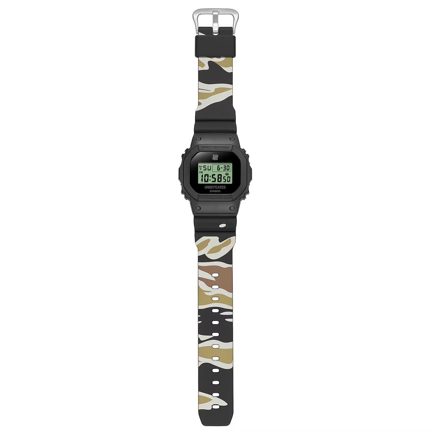 Casio G-SHOCK DWE5600UD-1 UNDEFEATED collaboration model with matte black Carbon Core Guard case, semi-translucent resin band featuring UNDEFEATED logo, green LCD display, engraved caseback, and special packaging. Includes two interchangeable camouflage straps (tiger camo, storm camo). Features shock resistance, mineral glass, 200m water resistance, LED Super Illuminator backlight, stopwatch, countdown timer, alarms, flash alert, auto-calendar, and ±15 sec/month accuracy. Case size 48.9 × 43.8 × 13.7 mm, we