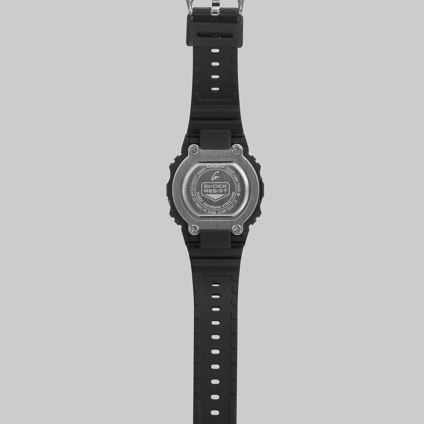 Black digital watch with a gray bezel on a light gray background