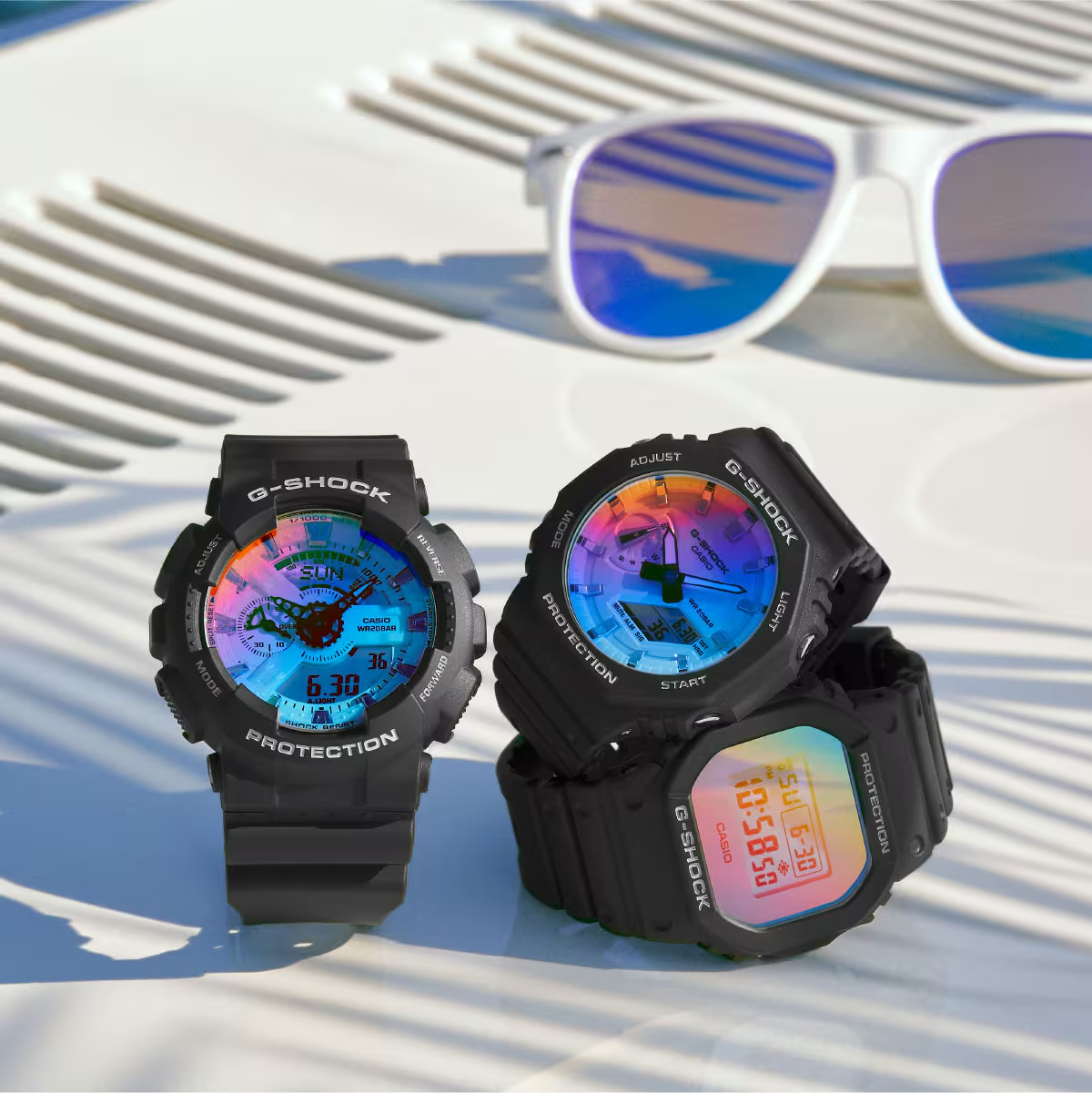 Two G-Shock watches with colorful displays on a light background