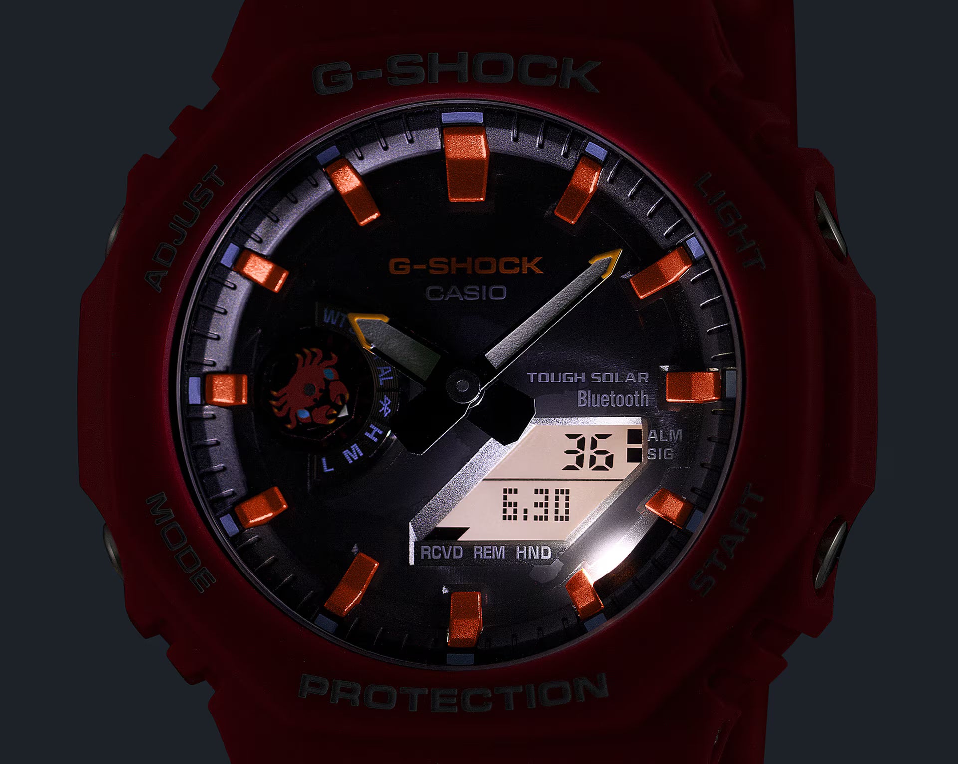 Red G-Shock Casio watch with digital display on a dark background