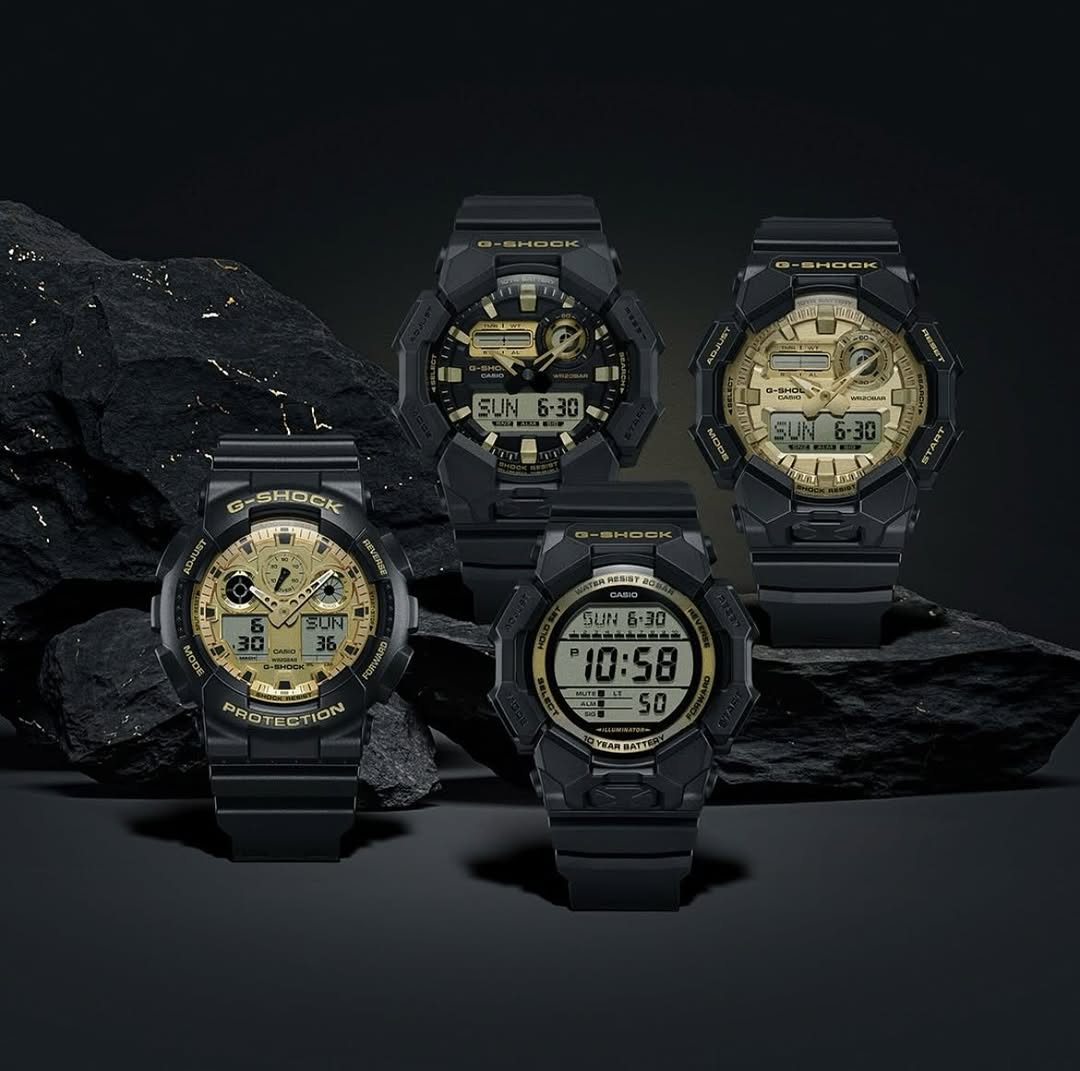 Casio G-SHOCK GA010GGB-1A9 watch with glossy black bio-based resin case and band, gold-tone vapor deposition accents, and gold mirror LCD. Large 55.1 × 51.9 × 17.5 mm Carbon Core Guard structure, shock-resistant, with mineral glass and Neobrite coating. Features include 200-meter water resistance, LED Super Illuminator, world time (31 zones, 48 cities + UTC), stopwatch, countdown timer, 5 alarms with snooze, auto-calendar, and 12/24-hour display. Powered by CR2025 battery with approx. 10-year life.