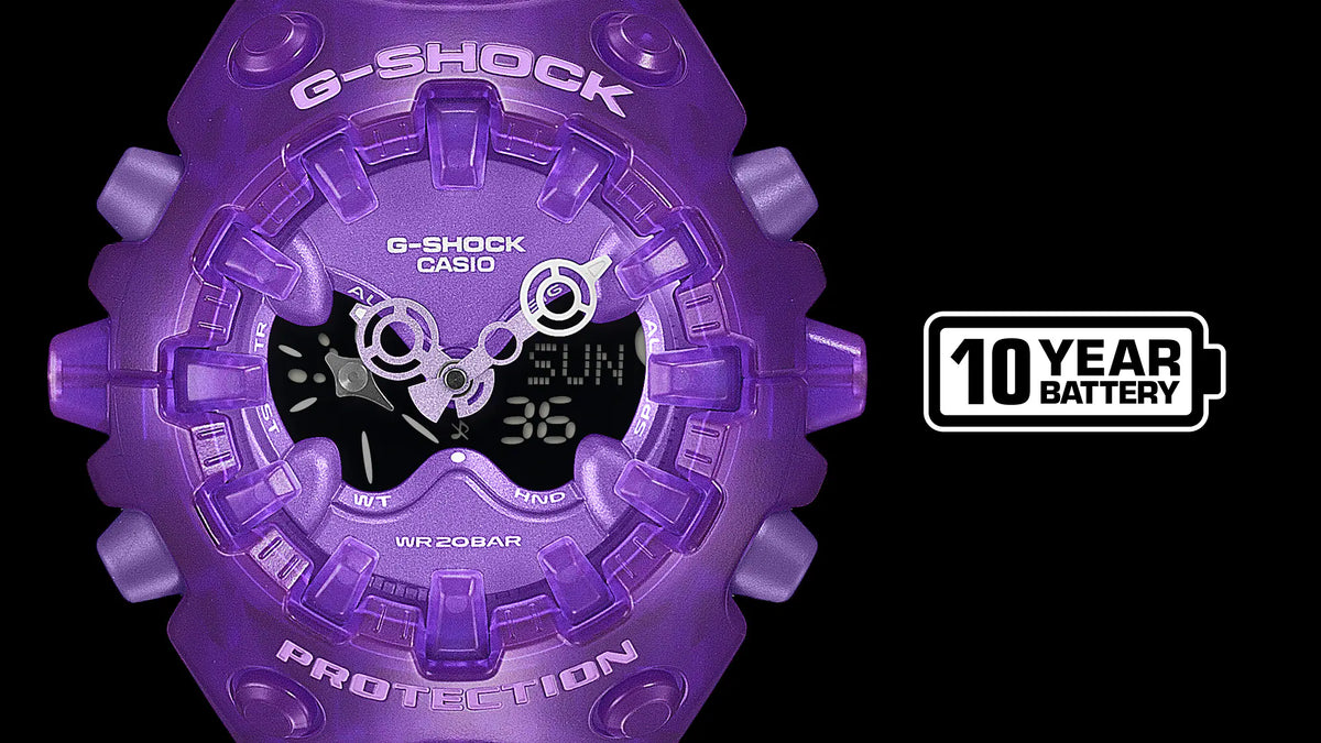 G-SHOCK GAV01SKE-6A purple translucent GA-V01 watch detail with full-screen LCD, Shock Release Hand design, and 10-year battery life graphic.