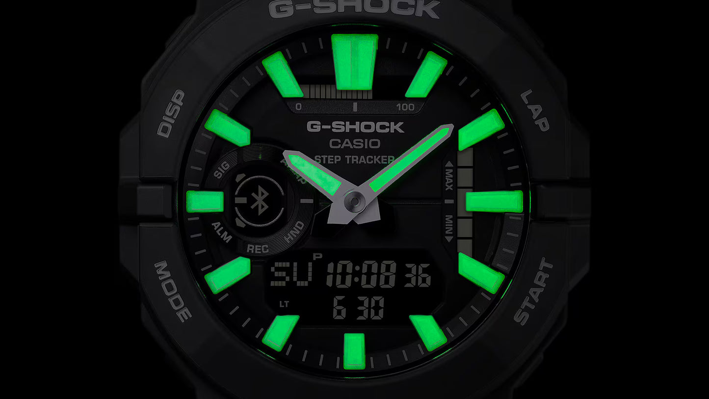 G-Shock Casio watch with green digital display on a black background