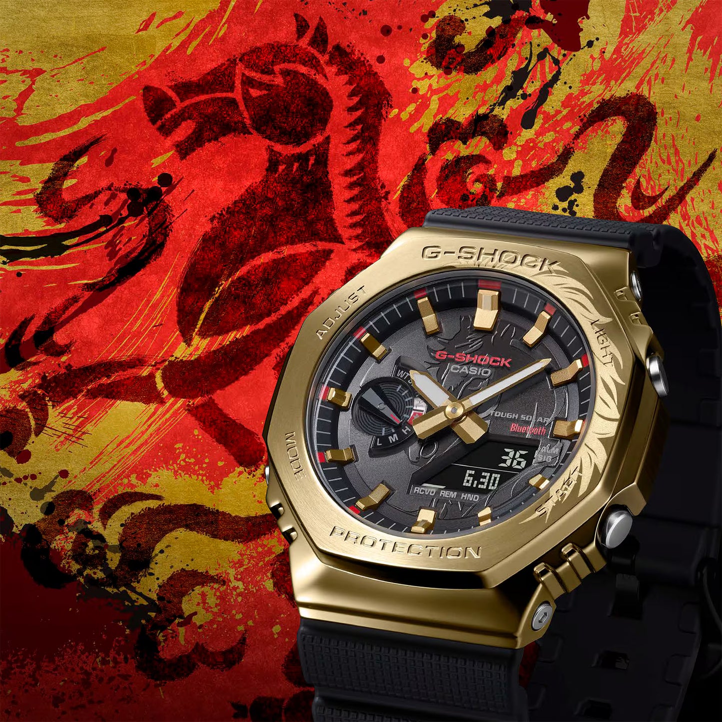 Gold Casio G-Shock watch on a red and yellow dragon background