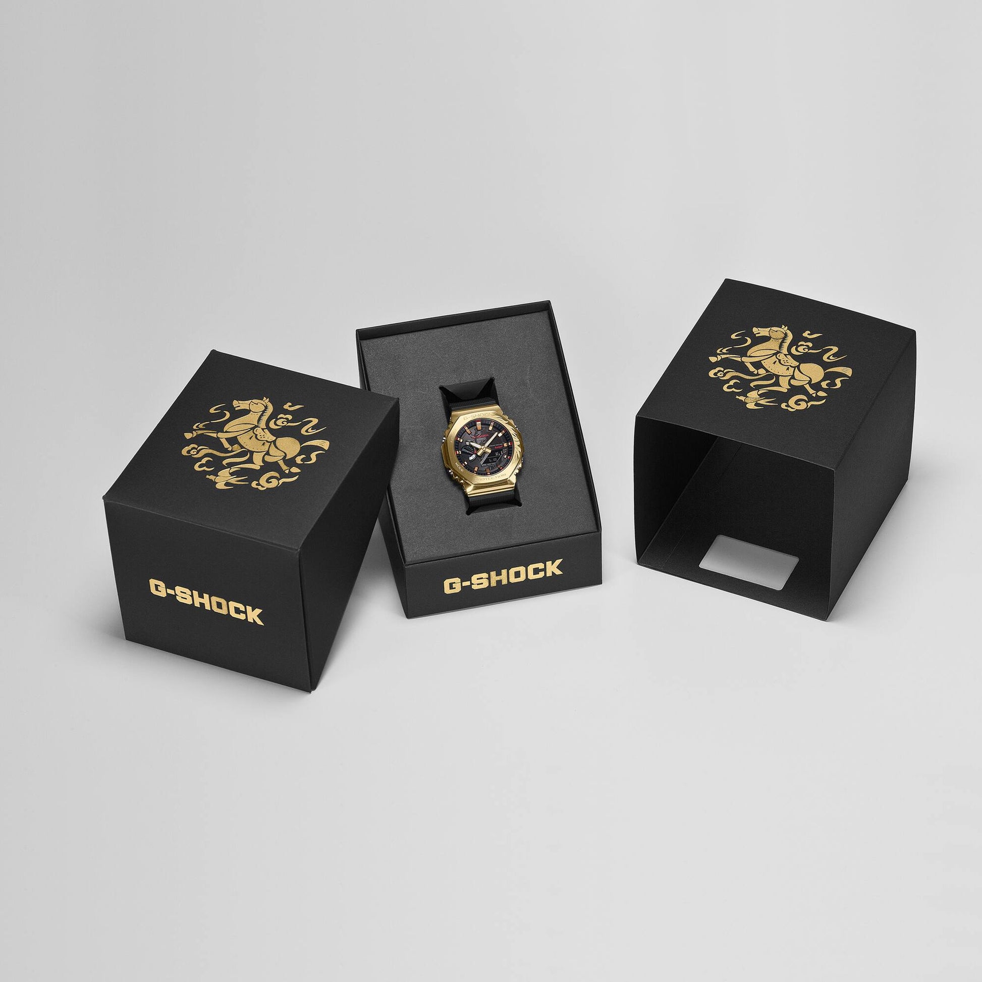 Gold G-Shock watch in a black box on a light gray background