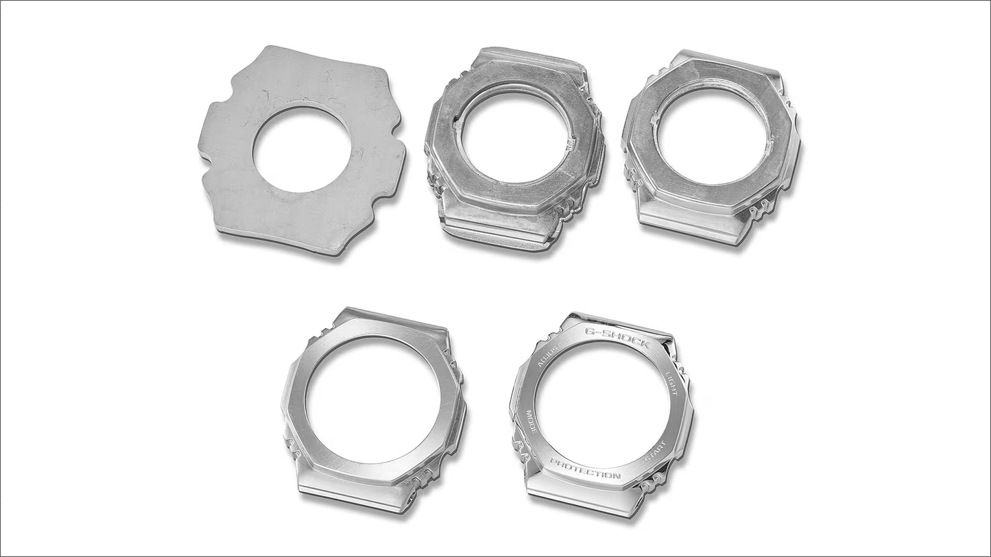 Five metallic mechanical components on a white background