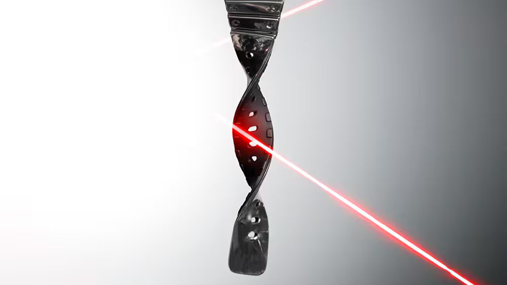 Spiral object with a red laser beam on a gradient gray background