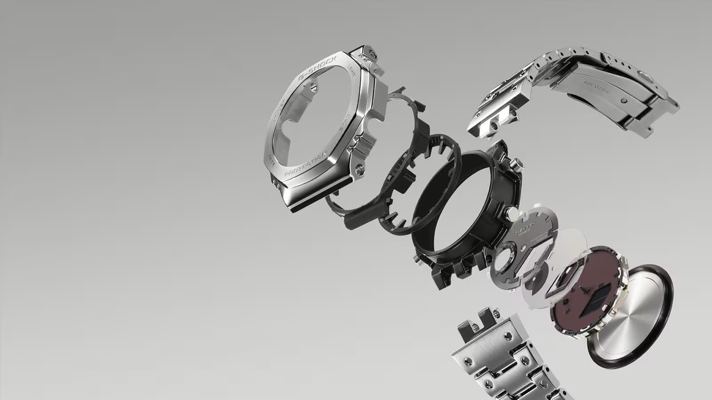 Watch parts including a case and strap on a gray background