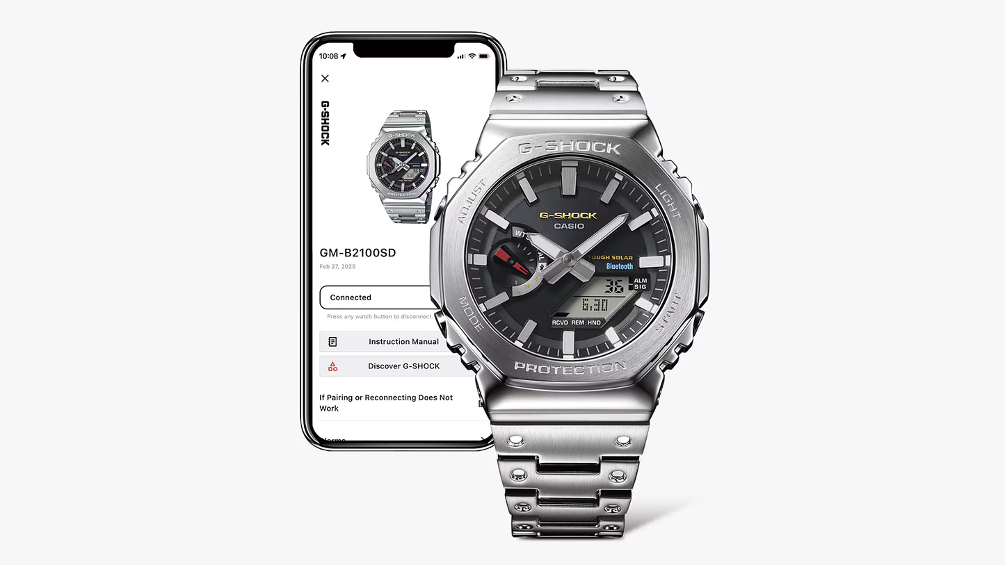 Silver Casio G-Shock watch next to a smartphone displaying the watch's app interface.