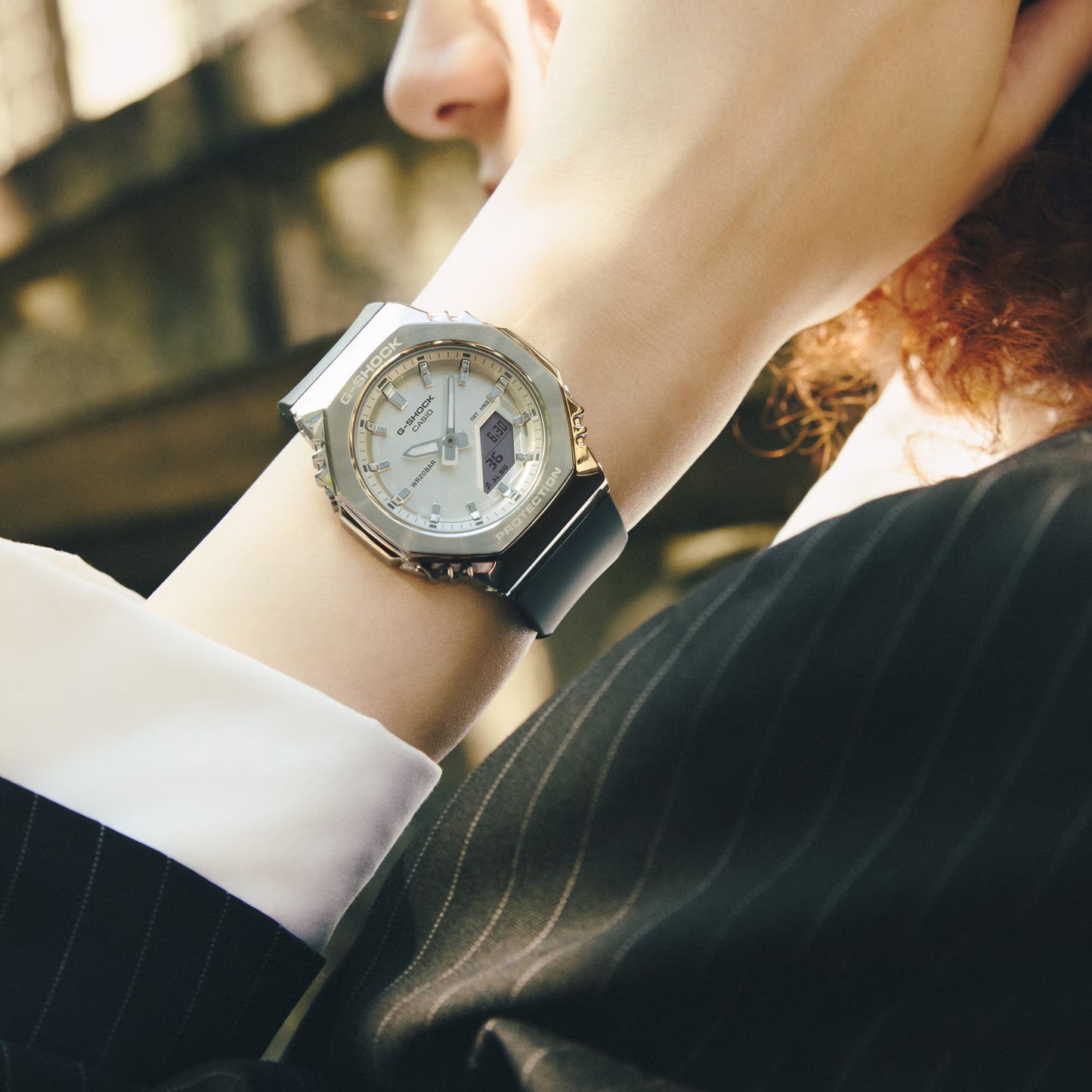 Person wearing a stylish watch with a blurred background