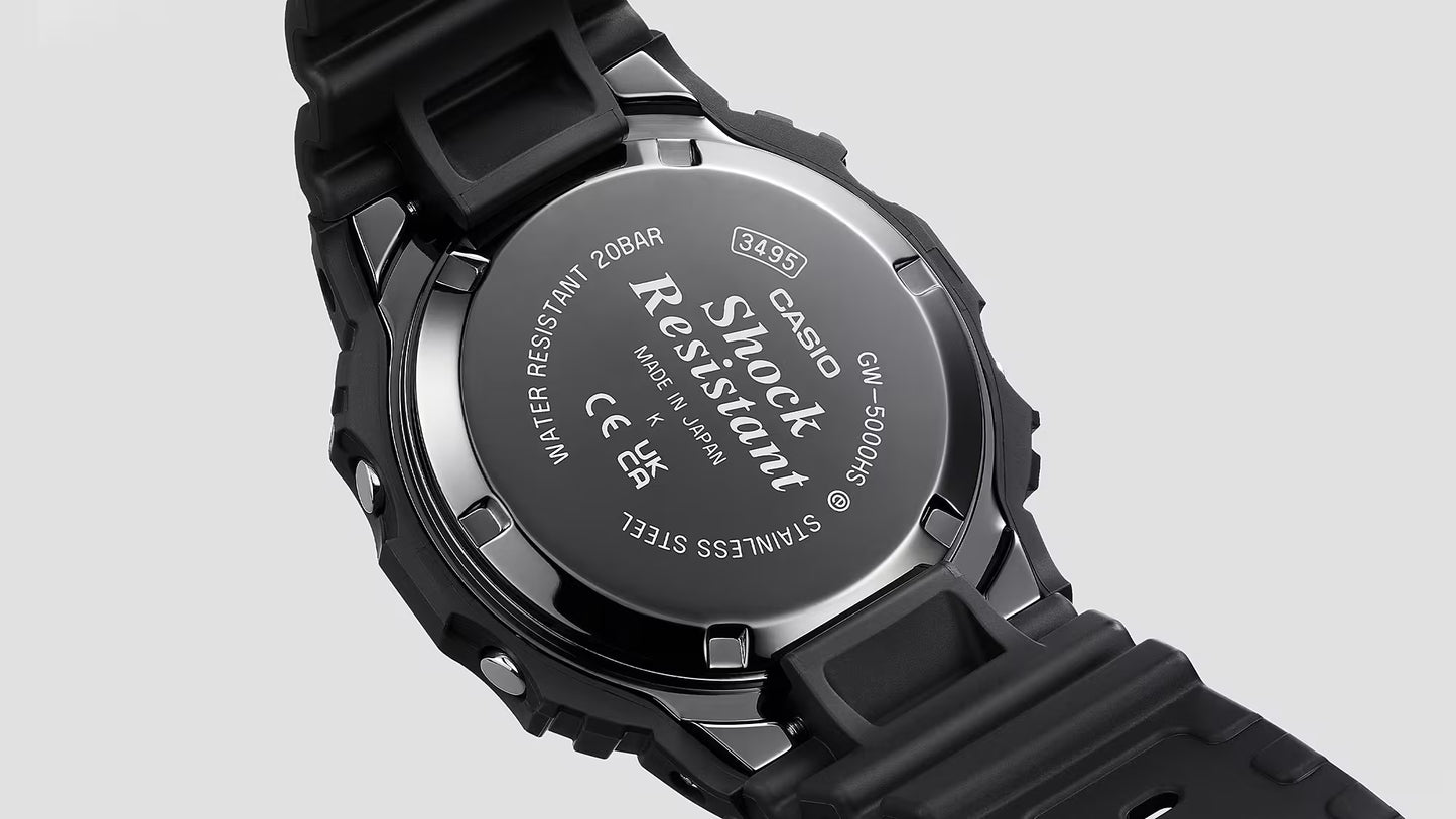 Back view of a Casio G-Shock watch with branding and certification details on a gray background