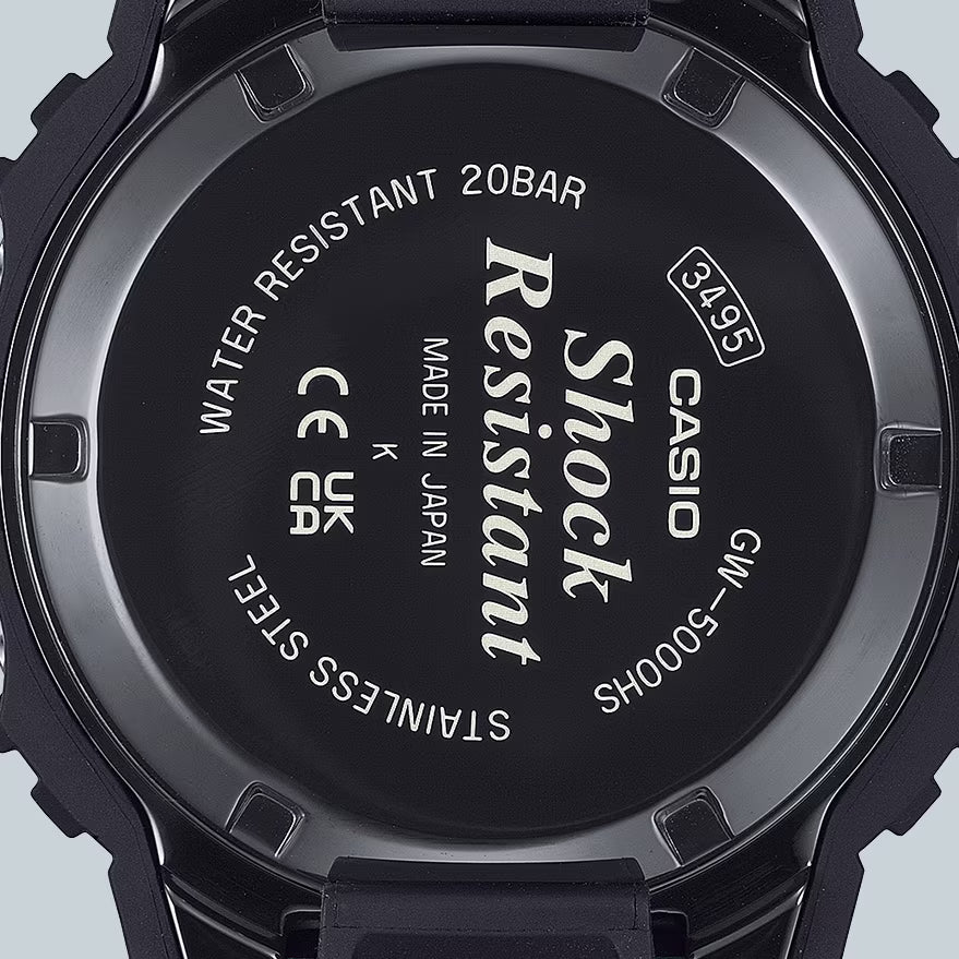 Back view of a Casio watch with branding and specifications on a light gray background