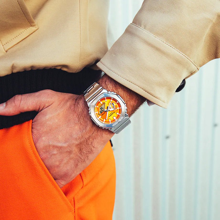 Casio G-STEEL GM2110D-4A, premium stainless-steel G-SHOCK with an octagonal bezel. Features a sunburst orange dial, shock resistance, 200m water resistance, dual LED Super Illuminator, and world time. Stylish and durable.