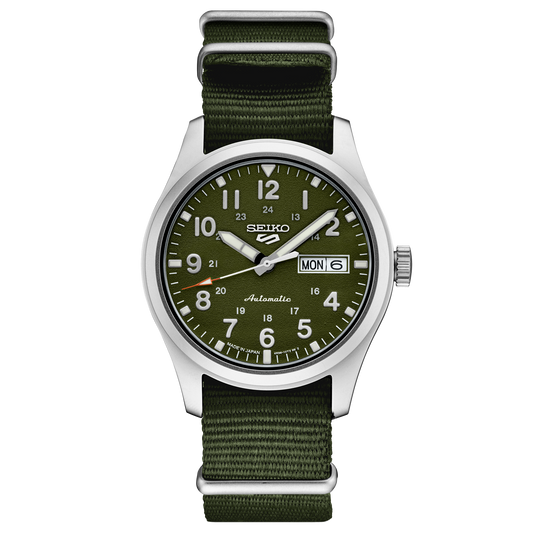 A SEIKO 5 SPORTS SRPG33 watch with a green dial, Arabic numerals, and a stainless steel case. It features a green nylon strap and a screwdown see-through caseback.