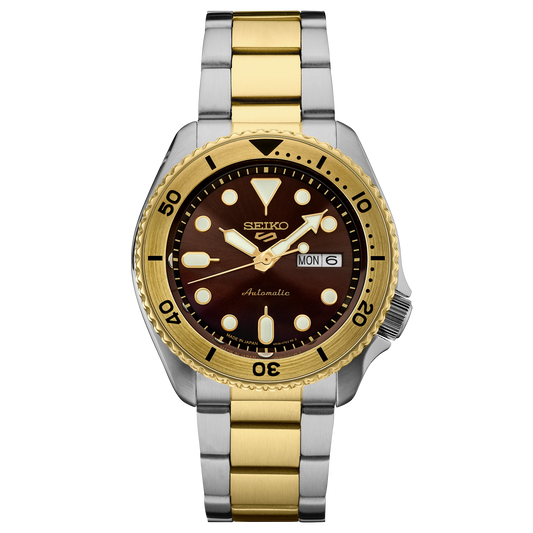 Seiko watch with gold and silver band on a white background