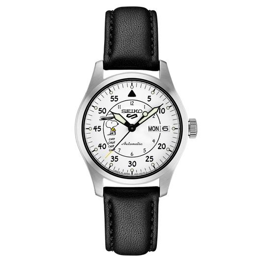A SEIKO 5 Sports watch with a white dial featuring Peanuts cartoon characters and a black leather strap.