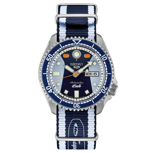 A SEIKO 5 SPORTS SRPK37 Honda Super Cub Limited Edition watch with a blue dial, orange accents, and a stainless steel case. Features a date display and a rotating bezel.