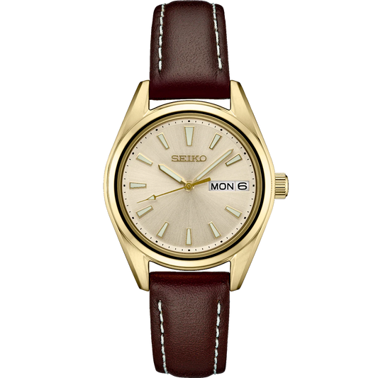 Seiko Essentials SUR456 – compact gold-tone dress watch with champagne sunray dial, brown leather strap, sapphire crystal, day/date display, and 100m water resistance.
