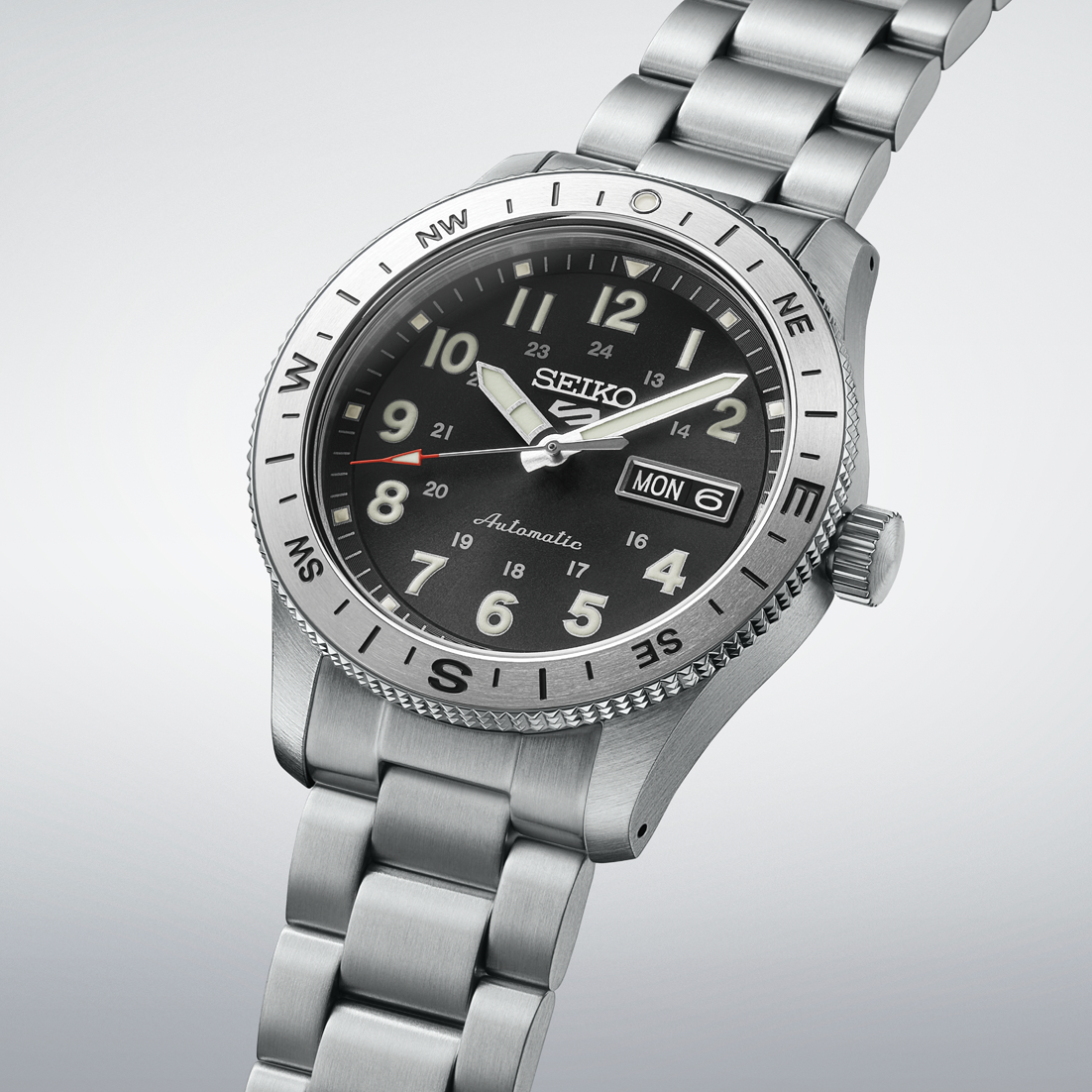 Silver Seiko watch with black dial on a light gray background