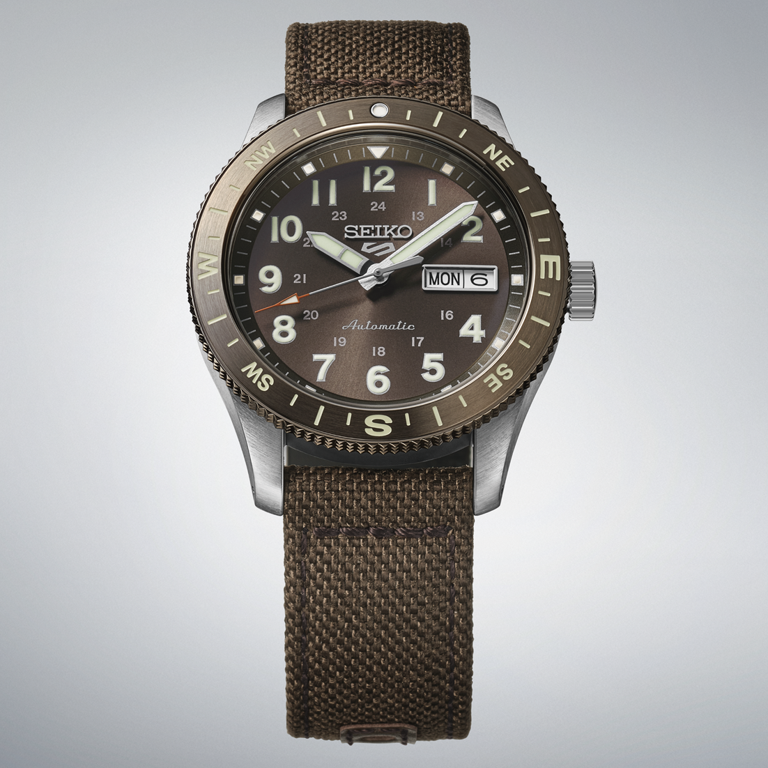 Seiko watch with brown strap and brown dial on a light gray background