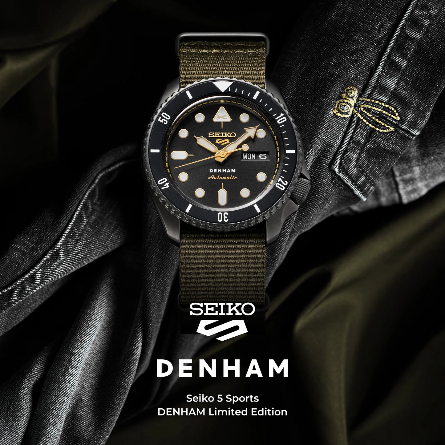 SEIKO 5 Sports SBSA283 DENHAM Limited Edition – black sunray dial with gold accents, stitching-inspired motif, black/gray rotating bezel, green nylon strap, automatic movement, and 100m water resistance.