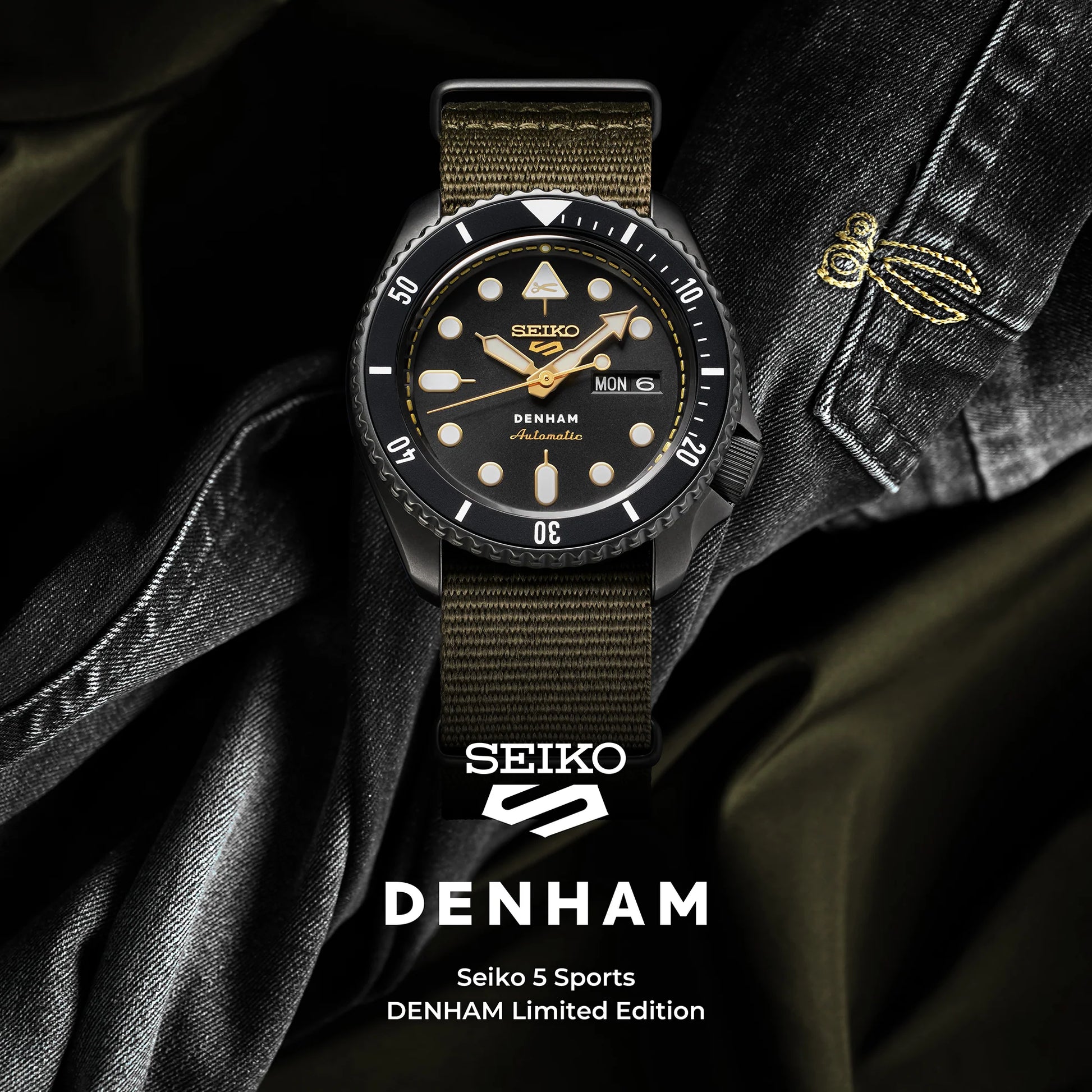 SEIKO 5 Sports SBSA283 DENHAM Limited Edition – black sunray dial with gold accents, stitching-inspired motif, black/gray rotating bezel, green nylon strap, automatic movement, and 100m water resistance.