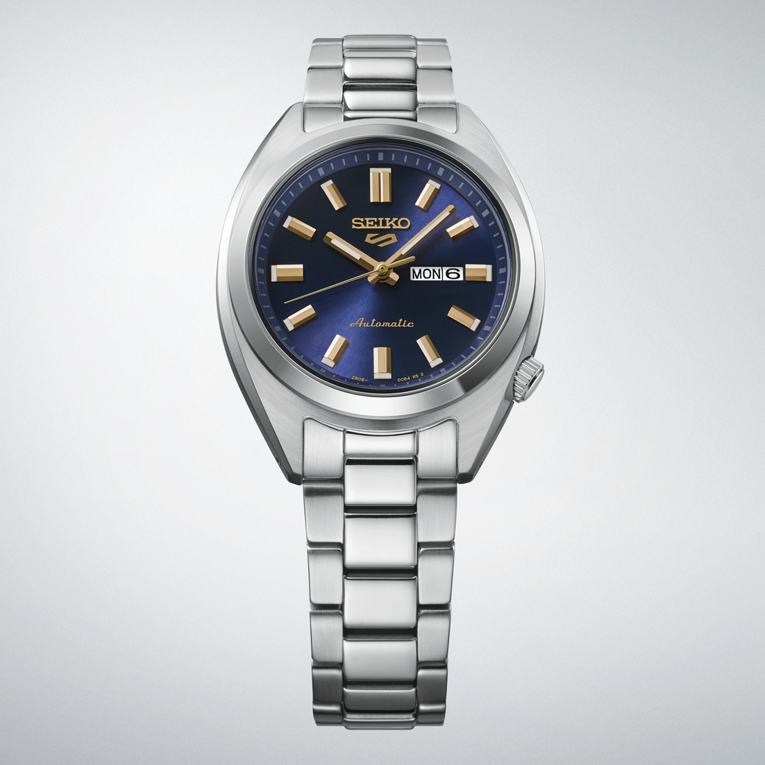 Silver Seiko watch with a blue dial on a light gray background
