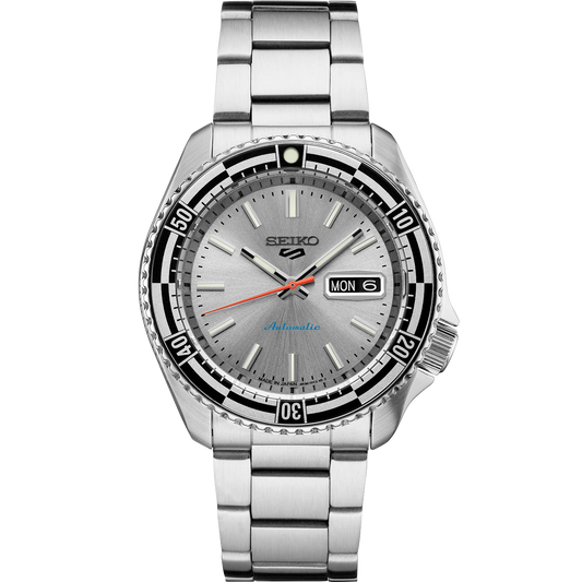 Seiko 5 Sports 55th Anniversary Special Edition automatic men's watch with silver dial, black and silver checkered rotating bezel, red-orange second hand, and stainless steel bracelet, inspired by the 1960s Seiko 5126-8130 model, available at Miseki Jewelry