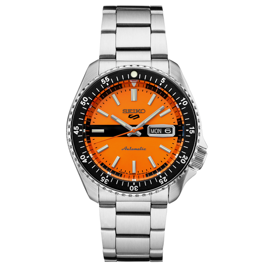 Seiko watch with orange dial and silver metal strap on a white background
