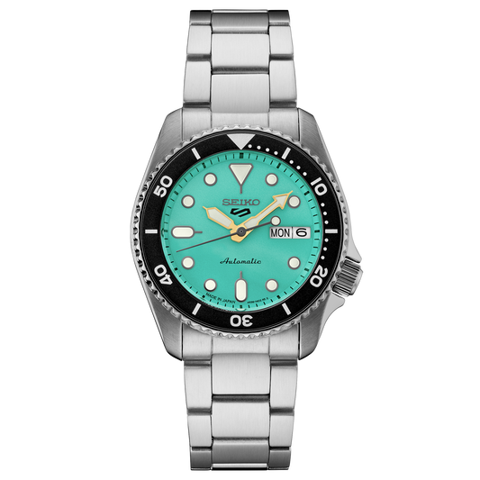 Seiko watch with turquoise dial and silver metal strap on a white background