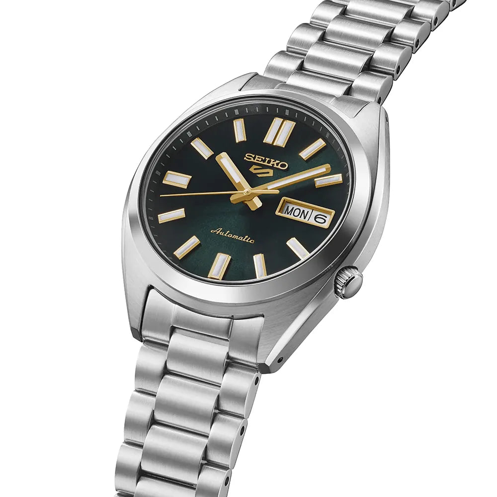 Silver Seiko watch with a dark green face on a white background