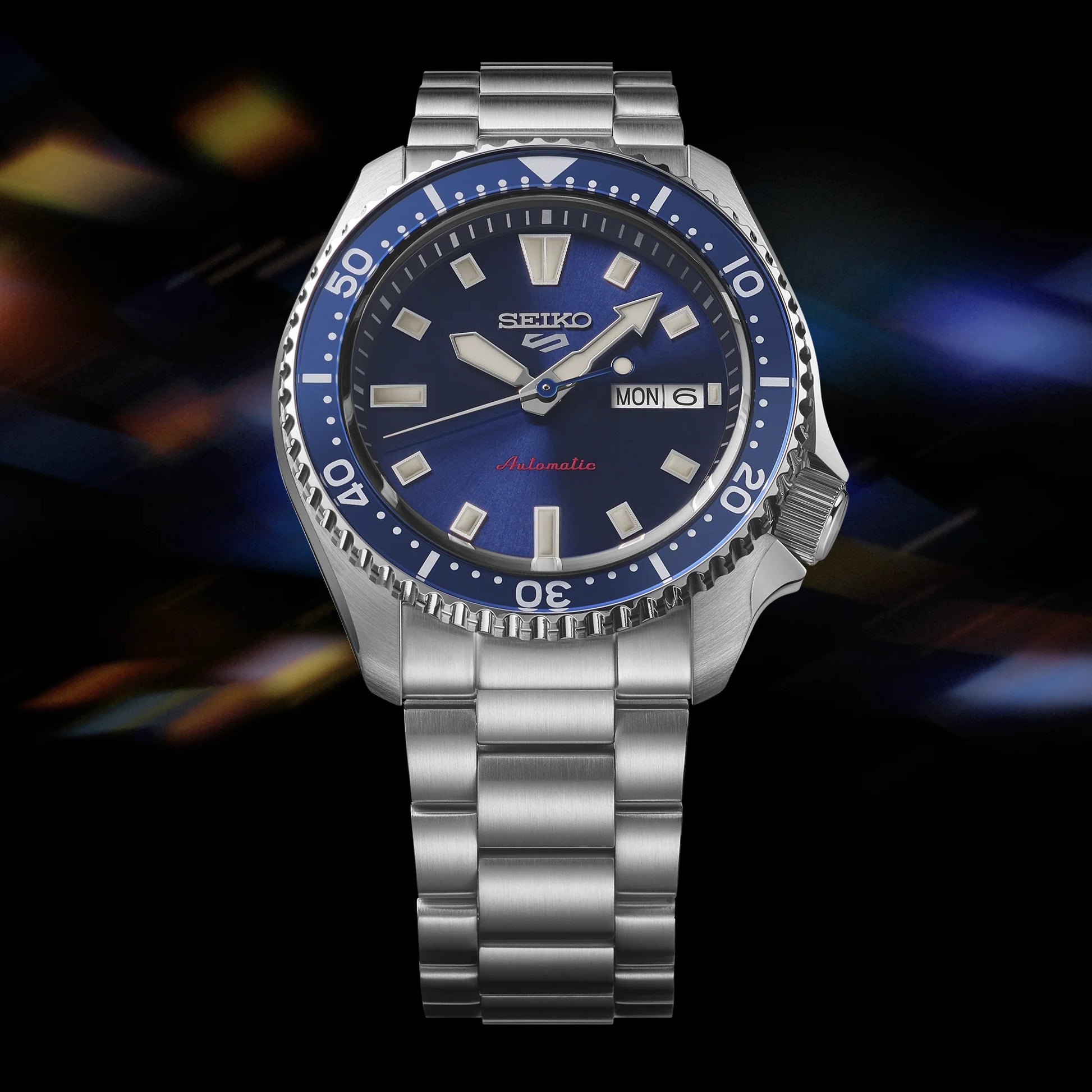 SEIKO 5 Sports SRPL83 SKX Sports Style – deep blue dial and bezel, stainless steel bracelet, automatic movement, and 100m water resistance.