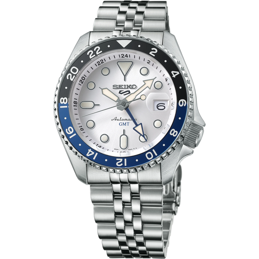 Seiko SSK033 GMT automatic watch with silver sunray dial, dual-tone blue and black 24-hour bezel, luminous hands, magnified date display, and stainless steel five-row bracelet — SKX-inspired GMT model available at Miseki Jewelry