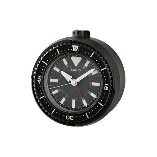 SEIKO QHE207KLH rotating bezel alarm clock with dark metallic case, black analog dial, bold markers, and sporty watch-inspired design.