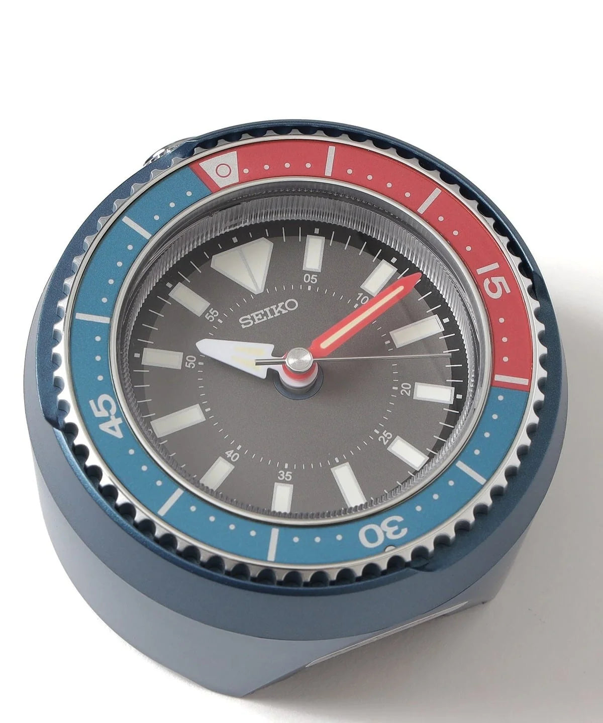 SEIKO QHE207LLH Heritage Design alarm clock with dark dial, luminous hands and markers, and bold red and blue rotating bezel.