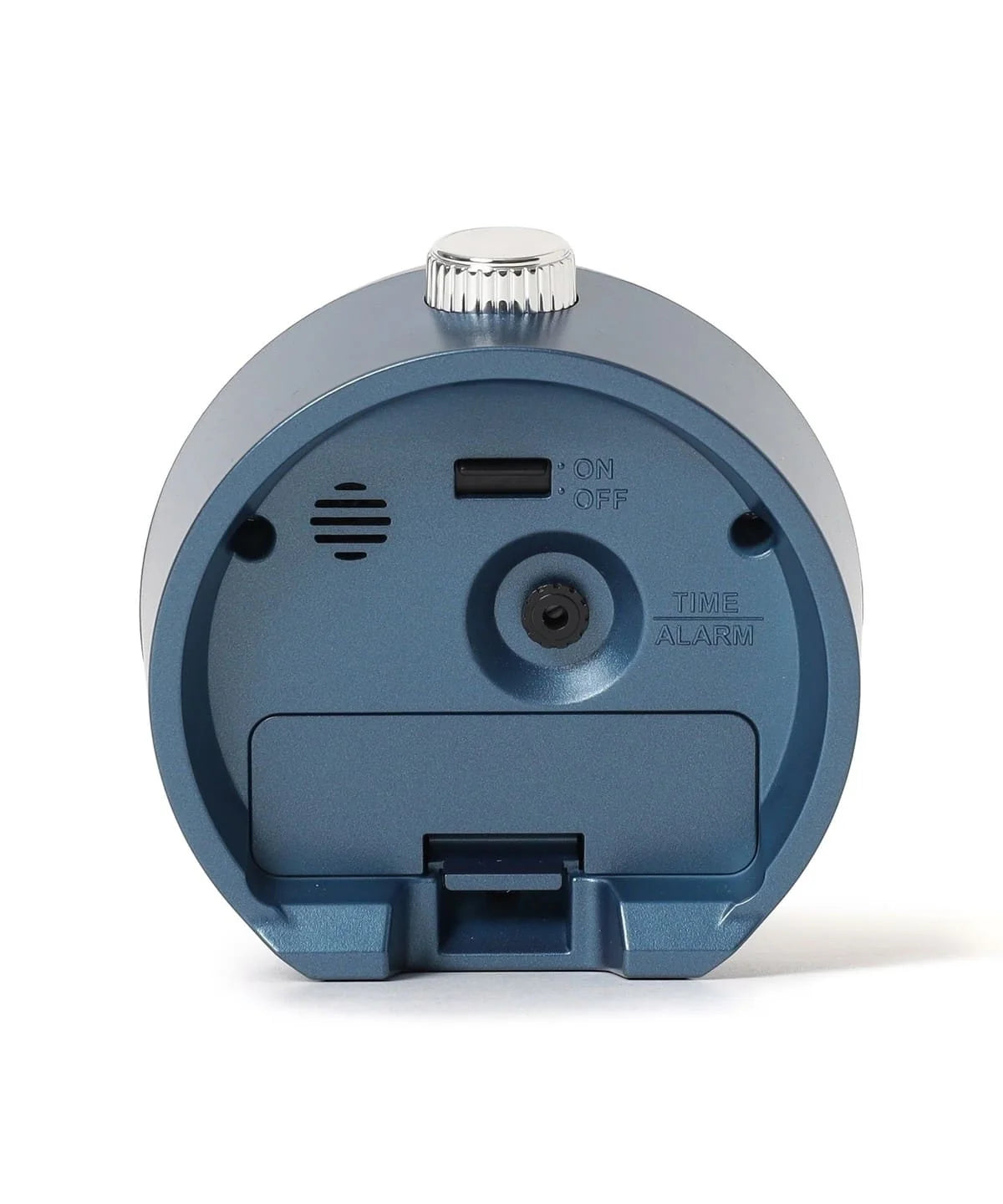 Back view of SEIKO QHE207LLH alarm clock showing rear alarm controls, on/off switch, speaker opening, time and alarm adjustment, and battery cover.