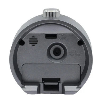Back view of SEIKO QHE207NLH alarm clock showing rear controls, alarm on/off switch, speaker opening, time and alarm adjustment, and battery cover.